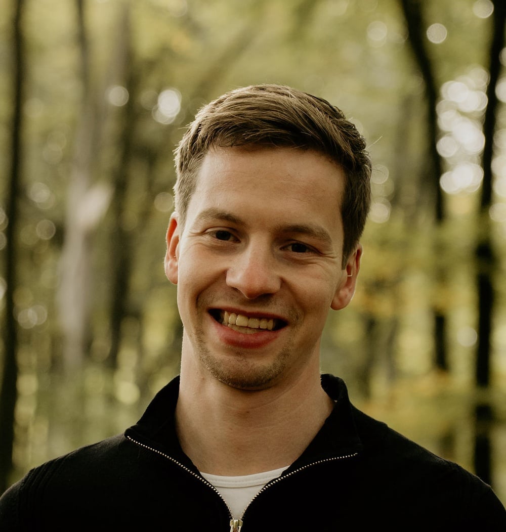 Ernst Jan Otten, adviseur ecologie bij idverde, glimlachend op de foto in bosrijke omgeving.