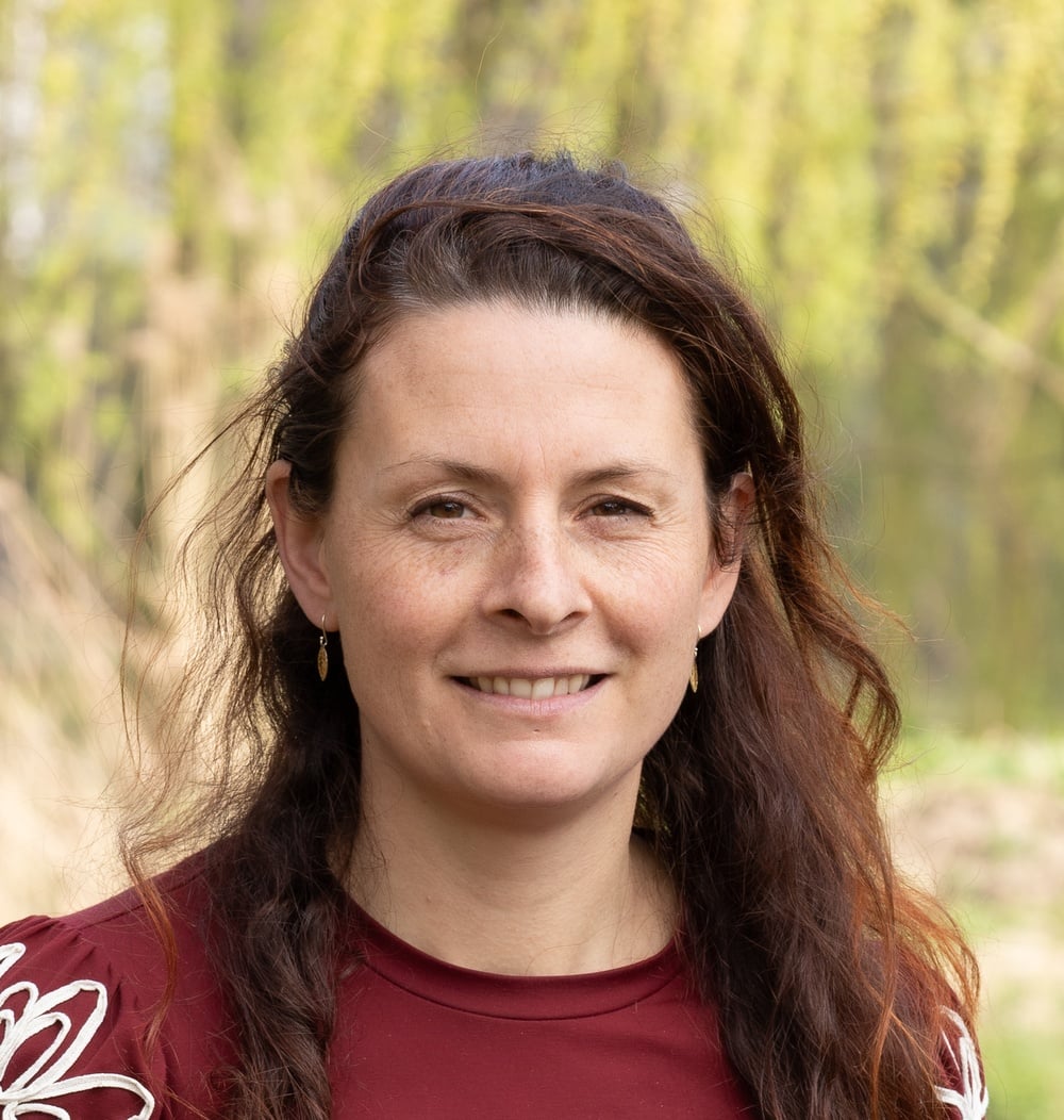 Lisa Gijsen, adviseur ecologie bij idverde, poseert buiten voor een portretfoto.