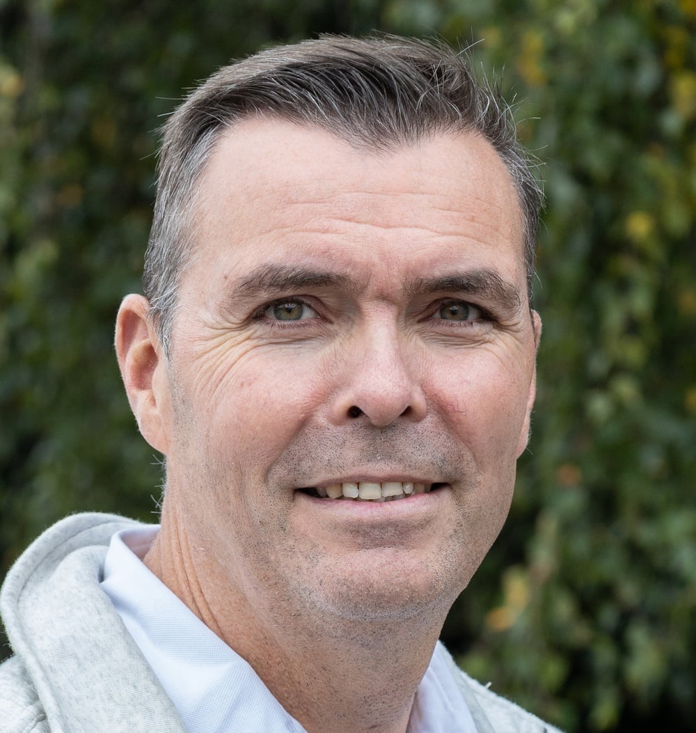 Pieter Zonneveld, regiomanager Noord bij idverde, poseert buiten voor groene beplanting.